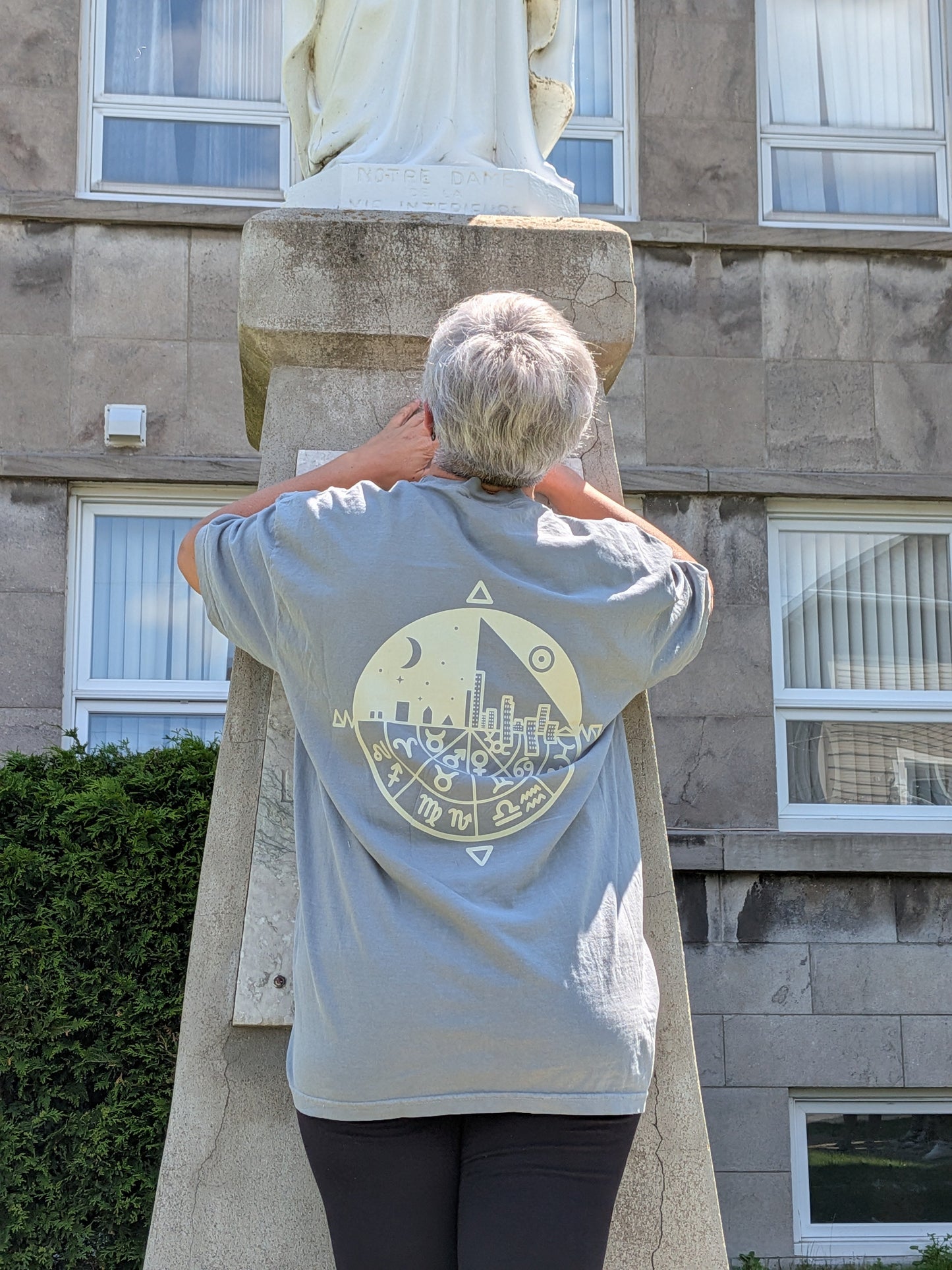 Celestial Wheel Tee — back view showing zodiac wheel sacred geometry graphic on sage tee