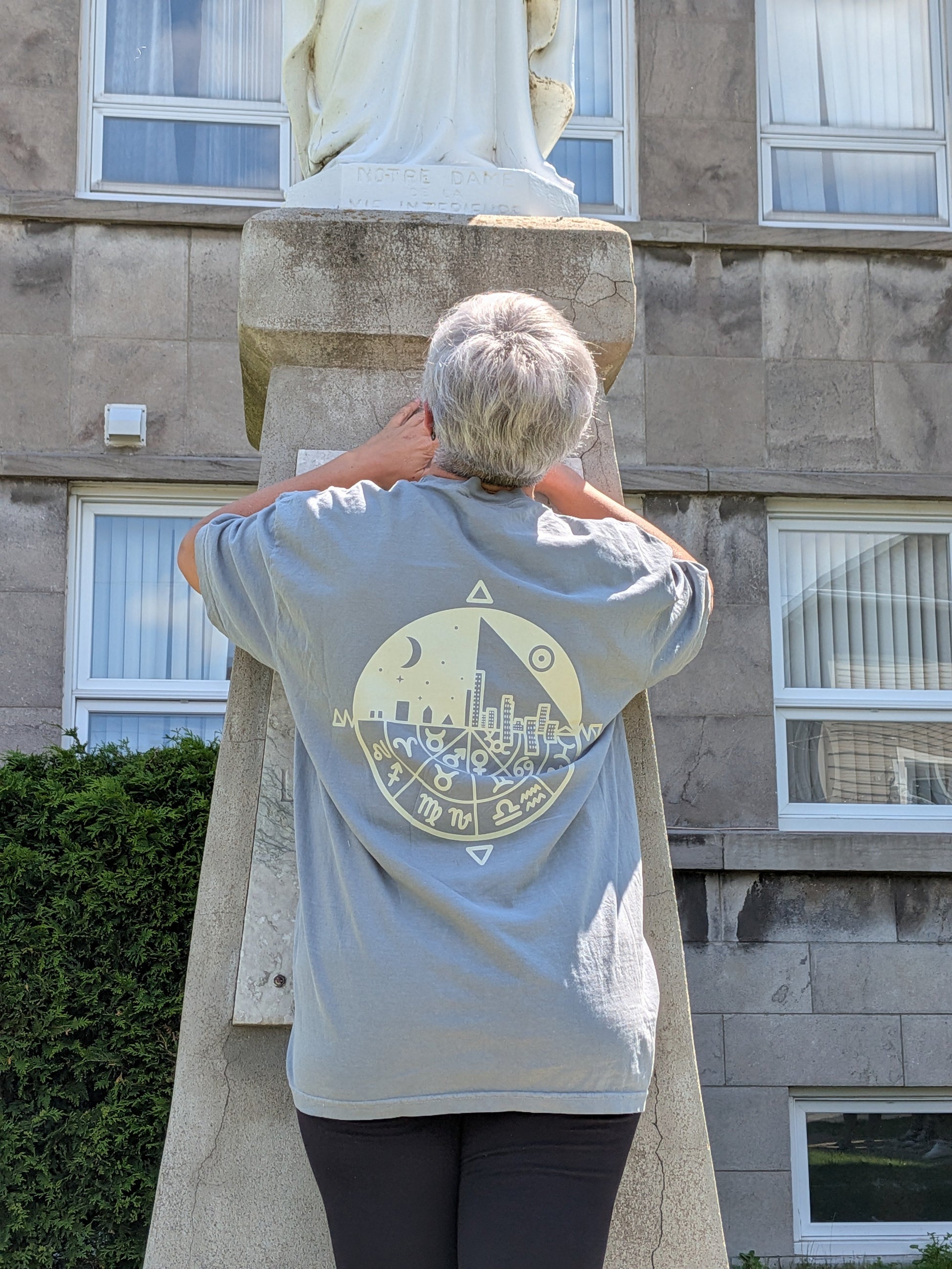 Celestial Wheel Tee — back view showing zodiac wheel sacred geometry graphic on sage tee